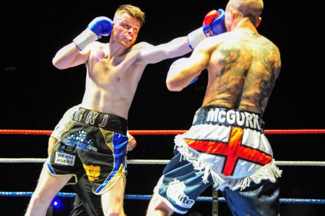 George Rhodes lands a left hand on Peter McGurk. Picture: Andy Standing.