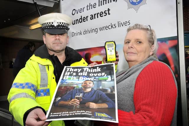 TC Paul Long with Lorraine Allaway who lost her husband after he was killed in a drunk driving accident..165025g