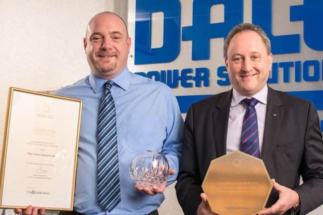 Mark Carter, business support manager, with CEO Tim Wilkins and awards.