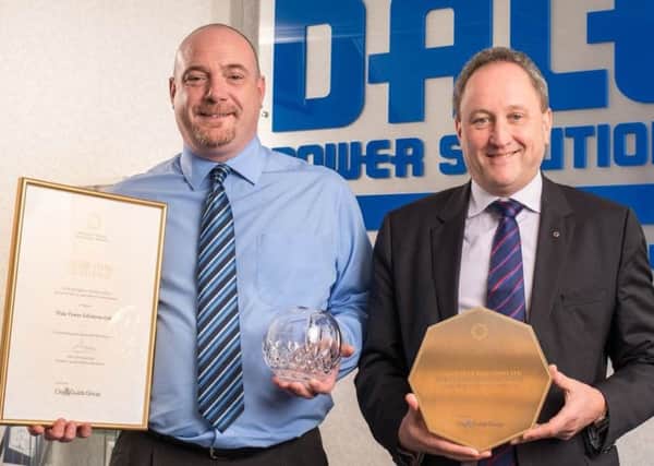 Mark Carter, business support manager, with CEO Tim Wilkins and awards.