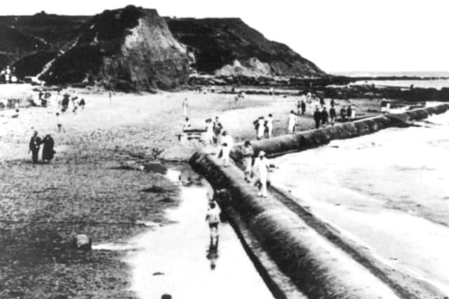 A view of the beach area at Scalby Mills. The strange looking mound in the centre of the picture was known as 'Monkey Island' a popular playground for many generations.
Visitors are taking advantage of low tide as they walk along the old Victorian outfall pipes which stretched as far as Jackson's Bay to the north.
Photo reproduced courtesy of the Max Payne collection.
Reprints can be ordered with proceeds going to local charities. Telephone 0330 1230203 and quote reference number