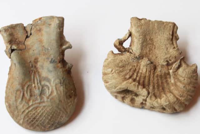The two small metal vessels in the archeology display in the Manor House, Ryedale Folk Museum.