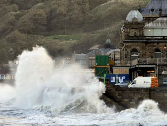 A flood alert has been issued at The Spa in Scarborough. Pictured: waves crashing against the sea wall in 2010.