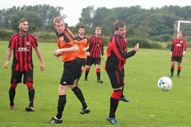 Edgehill's Luke Jenkinson, orange shirt, and West Pier's Neil Thomas, pictured in action last season