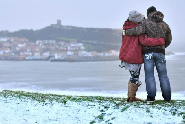 Taking in the view over Scarborough as the bitter wind blows across the bay