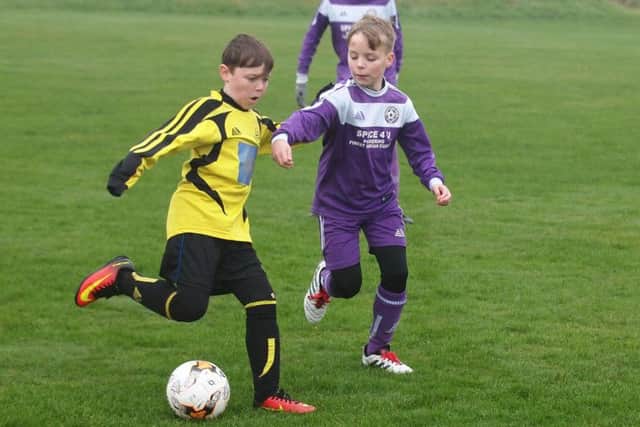 Scholes Park under-11s, yellow kit, take on Thornton Dale