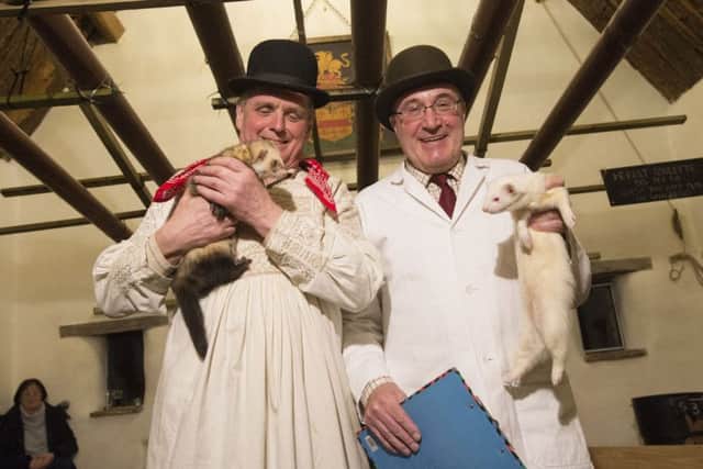 David Aynesworth holds his polecat ferret, whilst judge Simon Smith holds an Albino ferret, before the start of the evening's ferret racing at the Craven Arms pub, Appletreewick.