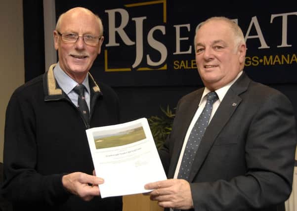 Colin Woodhead, left, accepts the golf vouchers from Ralph Shalom (RJS).