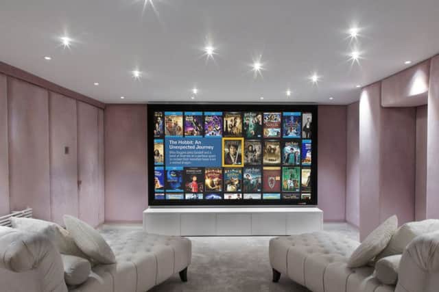 Cinema room with upholstered walls and day beds