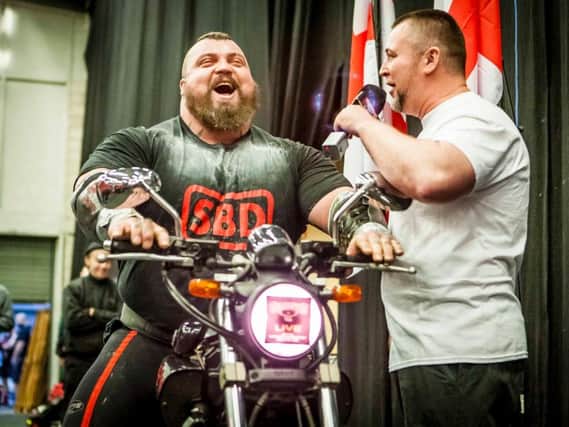 Strongman Eddie Hall rides off with motorbike prize after lifting Britain's Strongest Man title at Doncaster Dome. Photos: Marisa Cashill.