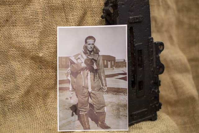 Denys Teare in his air-man's flying suite and part of the Lancaster Browning .303 gun.