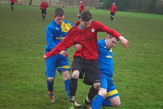 Two Eastway players converge on a Sherburn man during their 2-1 win in the Trophy Trader League Trophy quarter-finals. Picture: Steve Lilly.
