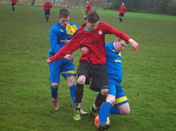 Two Eastway players converge on a Sherburn man during their 2-1 win in the Trophy Trader League Trophy quarter-finals. Picture: Steve Lilly.