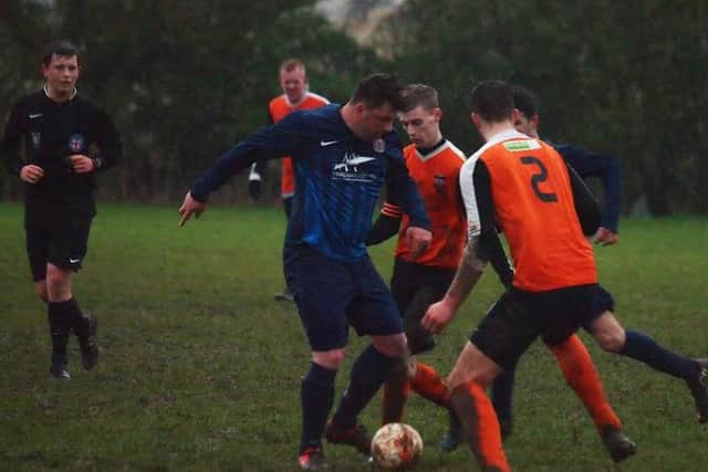 Angel Athletic's super-sub Dave Bell battles for possession during his side's 5-1 win against Ayton Reserves that wrapped up the Division Two title. Picture by Steve Lilly.