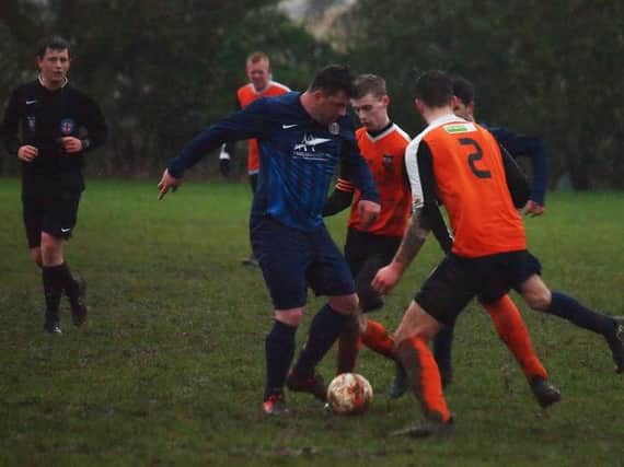 Angel Athletic's super-sub Dave Bell battles for possession during his side's 5-1 win against Ayton Reserves that wrapped up the Division Two title. Picture by Steve Lilly.