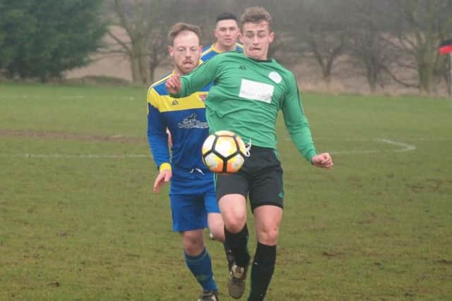 Sleights (green kit) get on the ball during their 3-2 defeat at Seamer. Pictures by Steve Lilly.