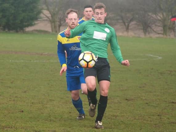 Sleights (green kit) get on the ball during their 3-2 defeat at Seamer. Pictures by Steve Lilly.