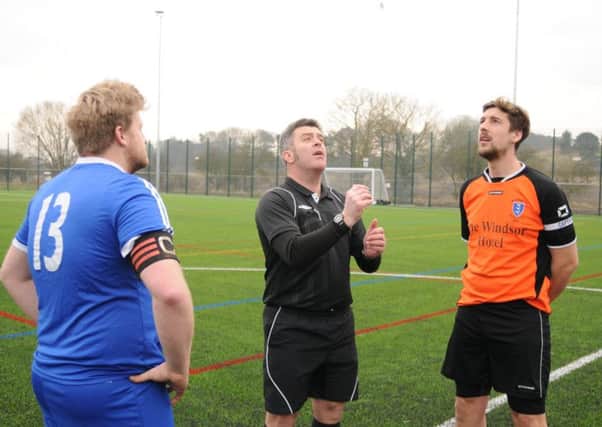 Flamborough 2nds captain James Hodgson, blue kit, and  Brid Rovers skipper Tom Broadbent look on as referee Mark Edwards tosses the coin before the first-ever game at the new 4G pitch in Bridlington