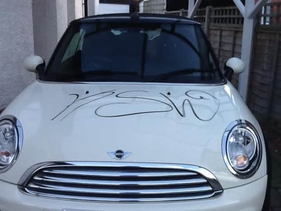 The letters KSW and ZELK have been written on cars and homes