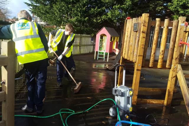 Apprentices clean up the play park at Ayton.