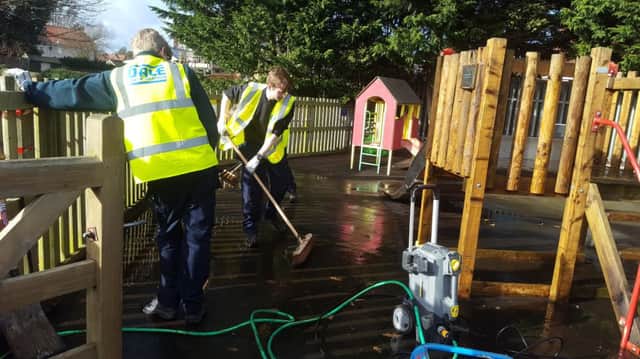 Apprentices clean up the play park at Ayton.