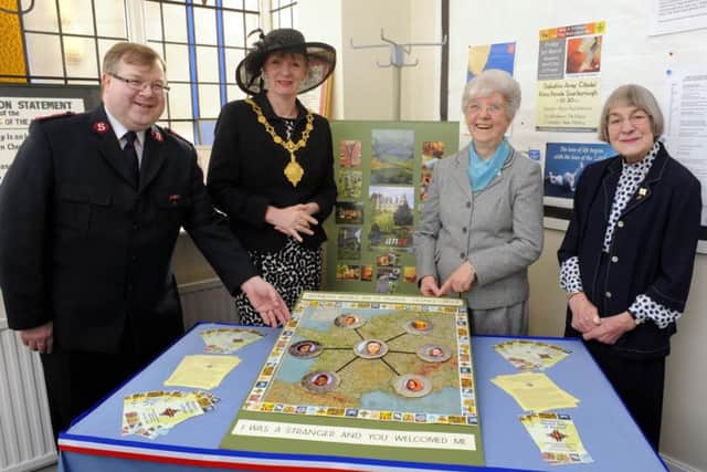 130937b  Mayor Helen Mallory attends the Women's World Day of Prayer service , at the Salvation Army Citadel, pictured with Major Paul Robinson, Patricia Mollon, and Jean Glover MBE, looking at a WW2 silk map of Europe, part of the display to mark the day. Photo by Andrew Higgins    01/03/2013