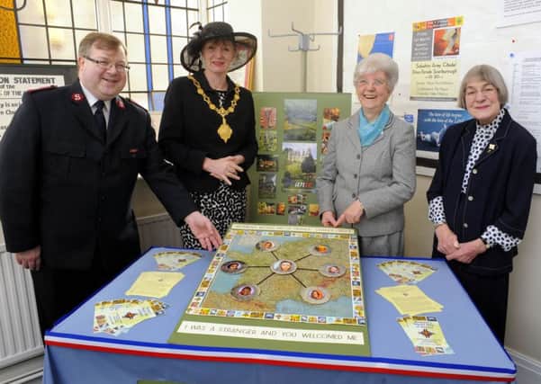 130937b  Mayor Helen Mallory attends the Women's World Day of Prayer service , at the Salvation Army Citadel, pictured with Major Paul Robinson, Patricia Mollon, and Jean Glover MBE, looking at a WW2 silk map of Europe, part of the display to mark the day. Photo by Andrew Higgins    01/03/2013