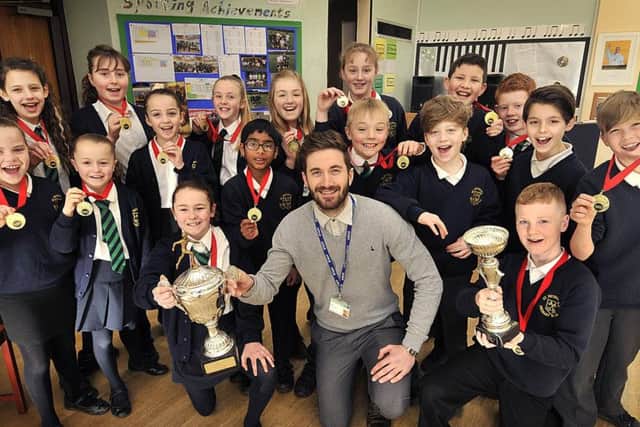 The successful St Peters youngsters show off the cup with sports co-ordinator Josh Greening 170810