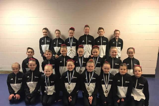 All the Challenge Level Four competitors from Scarborough Gymnastics Academy show off their medals