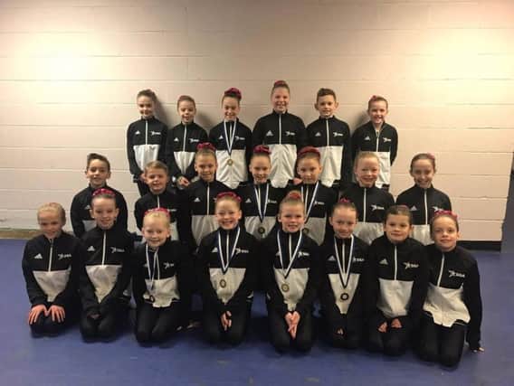 All the Challenge Level Four competitors from Scarborough Gymnastics Academy show off their medals