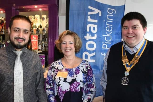 Spice4U manager Abdul Gaffer, Margaret Middlebrook (St Catherines) and Rotary Club president Luke Arnold.