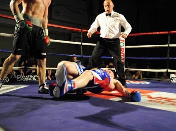 George Rhodes is floored by a huge overhand right from Dan West. Pictures by Andy Standing.