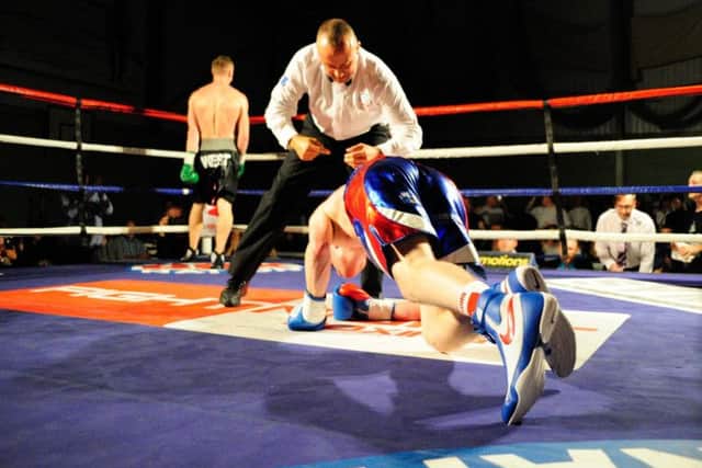George Rhodes Jr scrambles back to his feet after a knock down