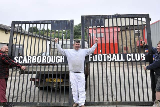 From left, Dave Morgan, Dave Hunter and Kev Matthews hold the iconic gates