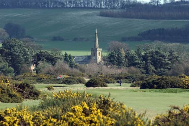A view down the 14th fairway of Ganton Golf Club with St Nicholas Church in the distance.
