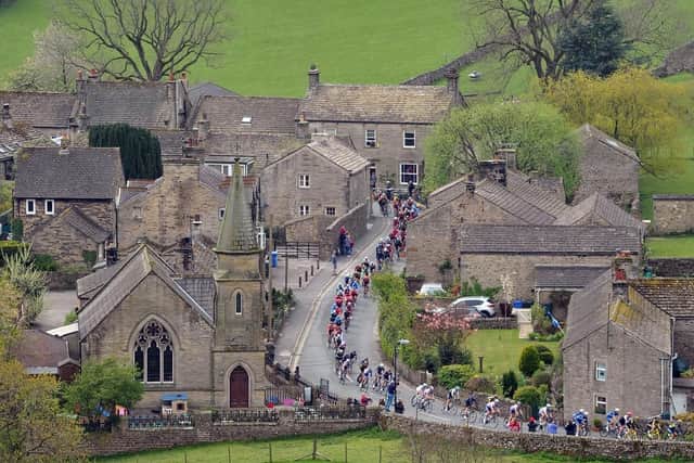 The Peloton passes through Burnsall in the Yorkshire Dales on the last leg of the race from Bradford to Sheffield. Picture: Tony Johnson