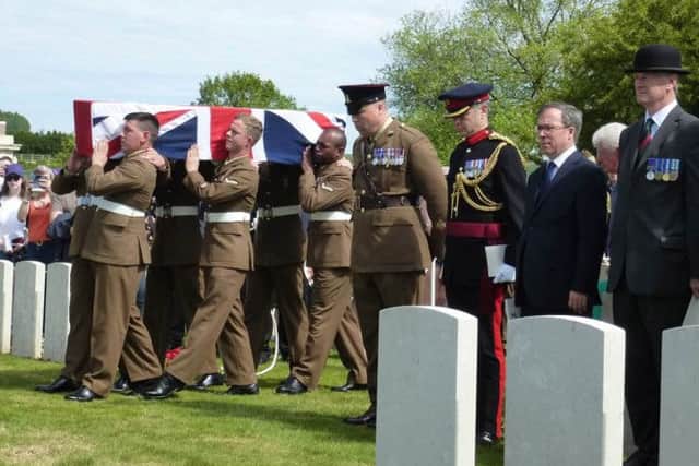 The bearer party from the Yorkshire Regiment carrying the coffin of PrivateHenry Parker in view of senior dignitaries.