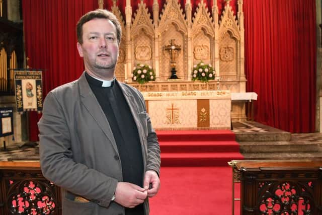 The Rev Matthew Pollard at the Priory altar