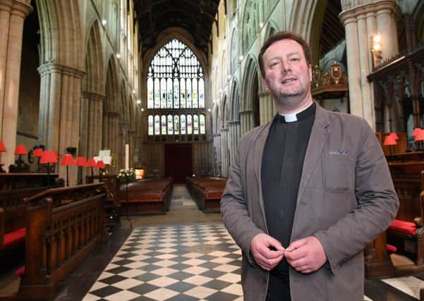 The Rev Matthew Pollard inside the Priory