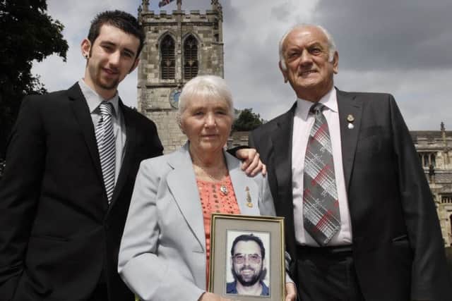 Pictured before the 2012 memorial service to mark the 20th anniversary of the murder of Special Constable Glenn Goodman are his son Thomas and parents Margaret and Brian. (120614M2a)