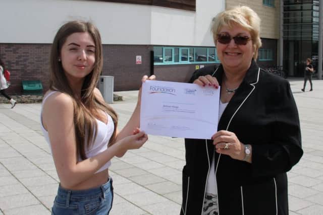 Marjorie Marks-Stuttle presents Jessica Heap with her certificate.