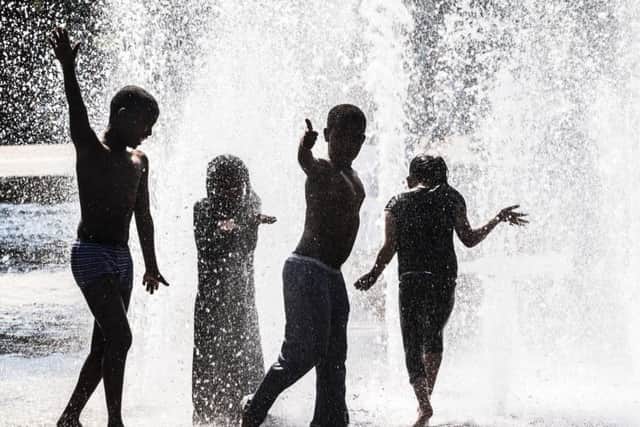 Children play in a water fountain in Bradford, Yorkshire, as Britain is set to bask in its hottest day of the year this weekend, with the fine weather continuing into next week.