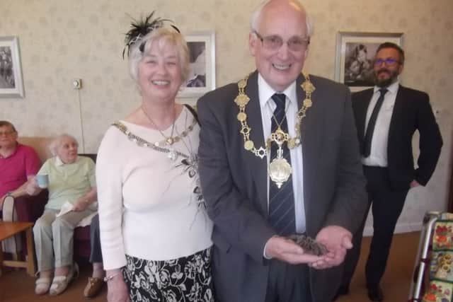 The Mayor of Scarborough Cllr Martin Price handles a spider while visiting Priceholme Residential Home.
