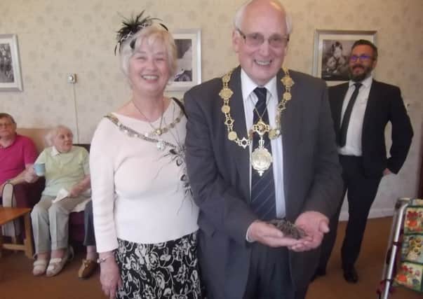 The Mayor of Scarborough Cllr Martin Price handles a spider while visiting Priceholme Residential Home.