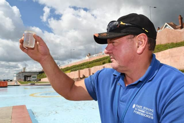 Dave Palmer checks on the water quality of the paddling pool