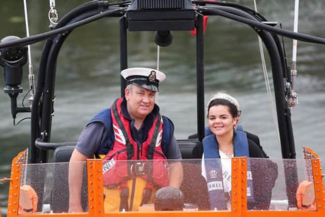 Whitby RNLI Coxswain Howard Fields with Miss Regatta Paris Mai Whisson aboard the lifeboat for the Whitby Regatta sail past. Saturday 18 August. Whitby Regatta 2017. Picture: Ceri Oakes w173002q