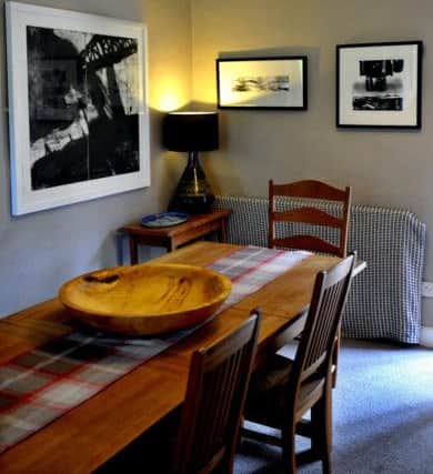 The dining area with Andrew's prints  on the wall and sycamore bowl by Peter Greenwood
