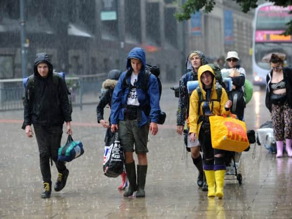 Early Leeds Festival goers brave the rain in Leeds this morning. Picture Jonathan Gawthorpe