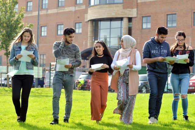 Juliana Kalniana, A*, Yusuf Khan, 9A*, Hansa Khan, 8A*, Iqra Hussain, 9A*, Arman Khan, 9A* and Alex Funk 9A* looking at their results at Dixons Trinity Academy, Bradford. Picture Bruce Rollinson