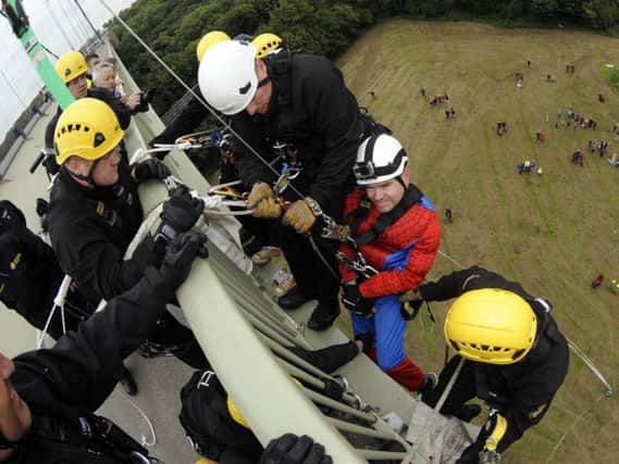 Jason Liversidge who has Motor Neurone Disease is pictured with his wife Liz, abseiling down the Humber Bridge.